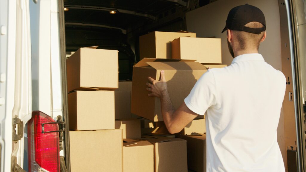 pexels-photo-5025665-5025665 Man Stacking Boxes in a Van